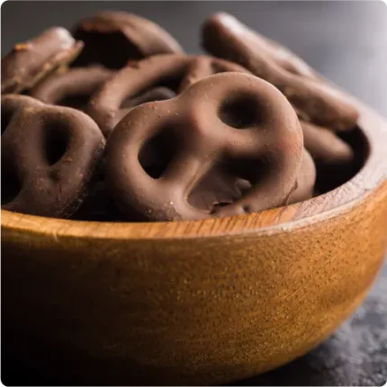 Chocolate covered pretzels in a wooden bowl