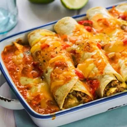 Red enchiladas on a serving tray closeup