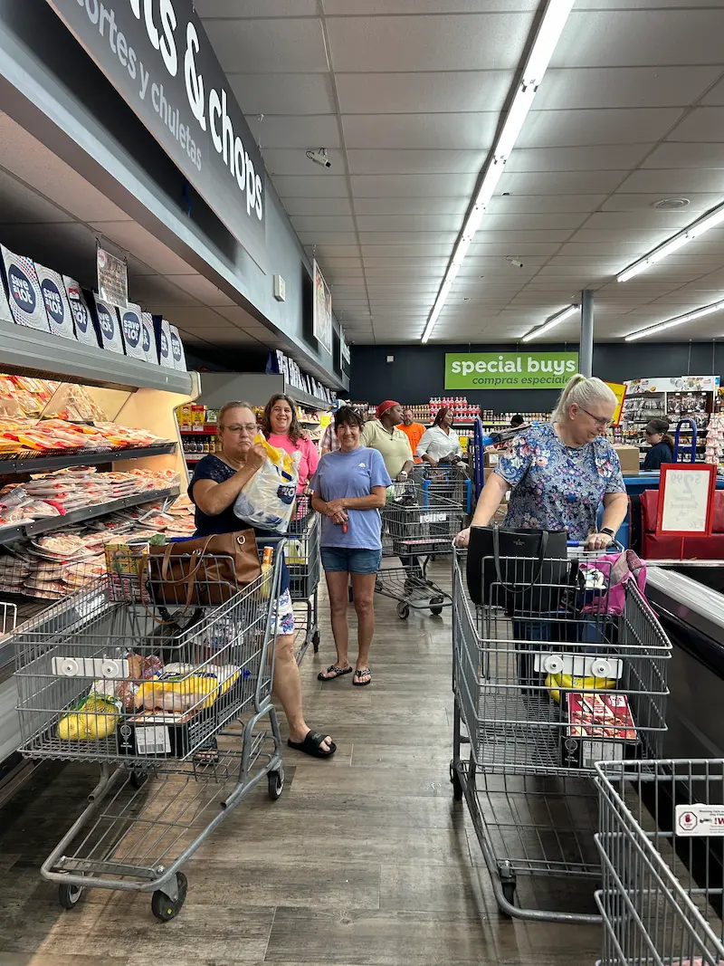 Customers shopping at Lake City Save A Lot store, owned by Mark and Josh Boris